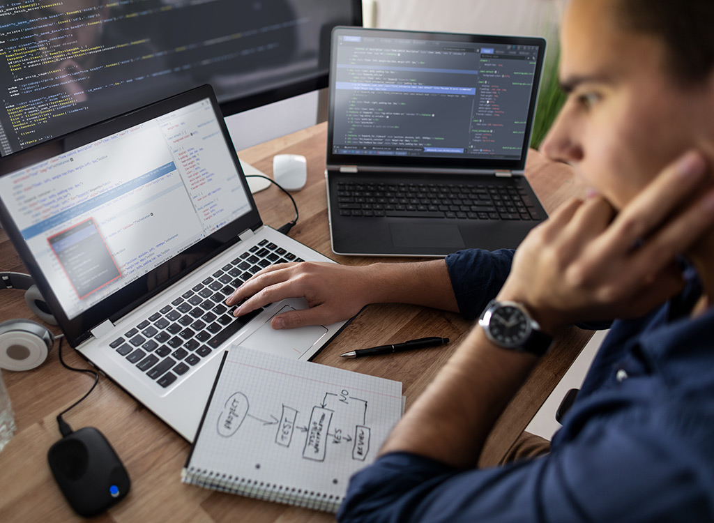 Redefine Web is a leading custom web development company visualized through a an image showing an employee looking at screen.